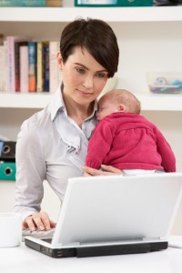Woman With Newborn Baby Working